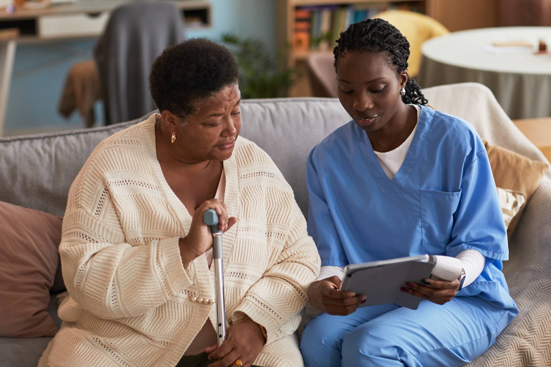 Caregiver showing a client information on a tablet