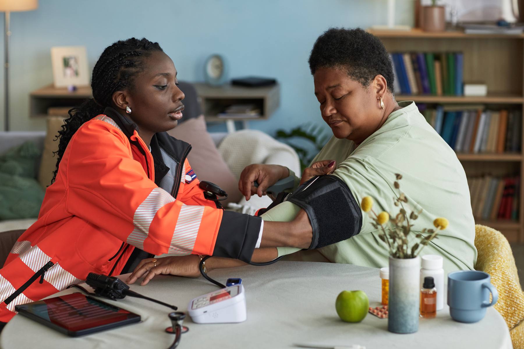 Nurse checking a client's blood pressure at home