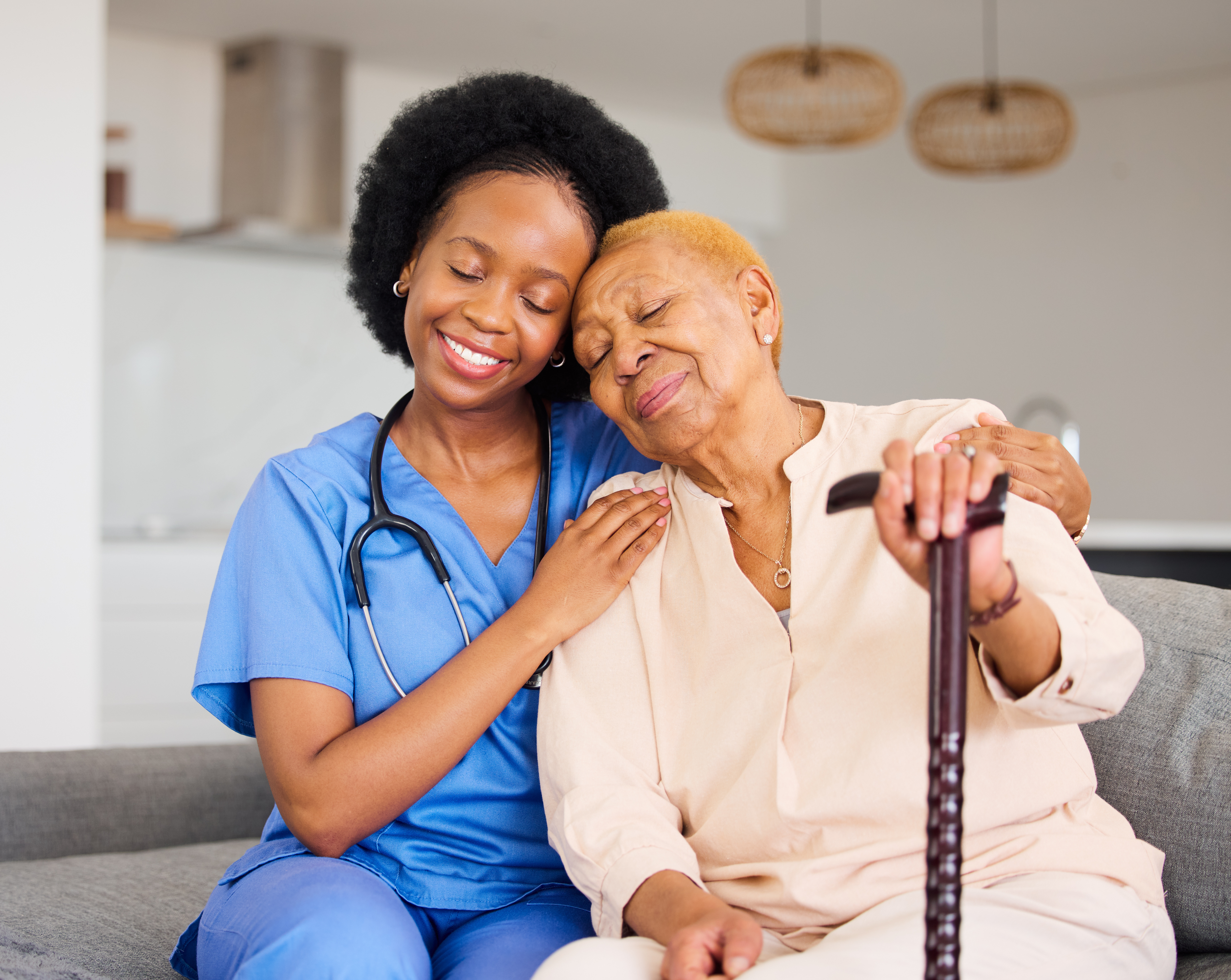 Caregiver smiling with a senior woman at home